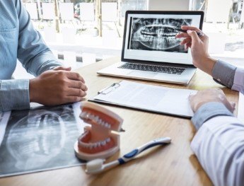 dentist showing patient x rays in Downers Grove