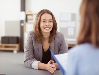 patient smiling at receptionist in Downers Grove